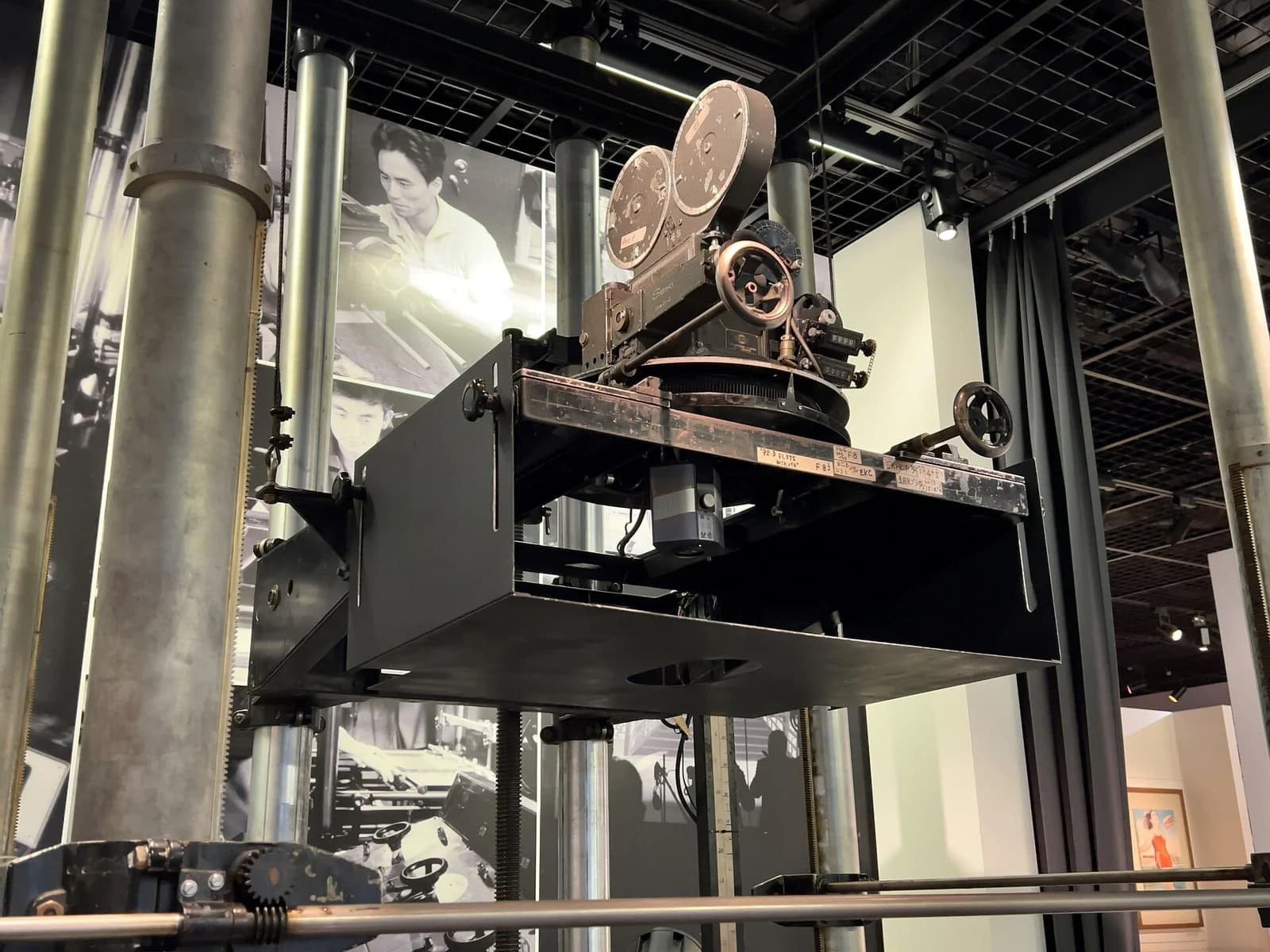 A historic animation camera and its mechanical support stand on display.