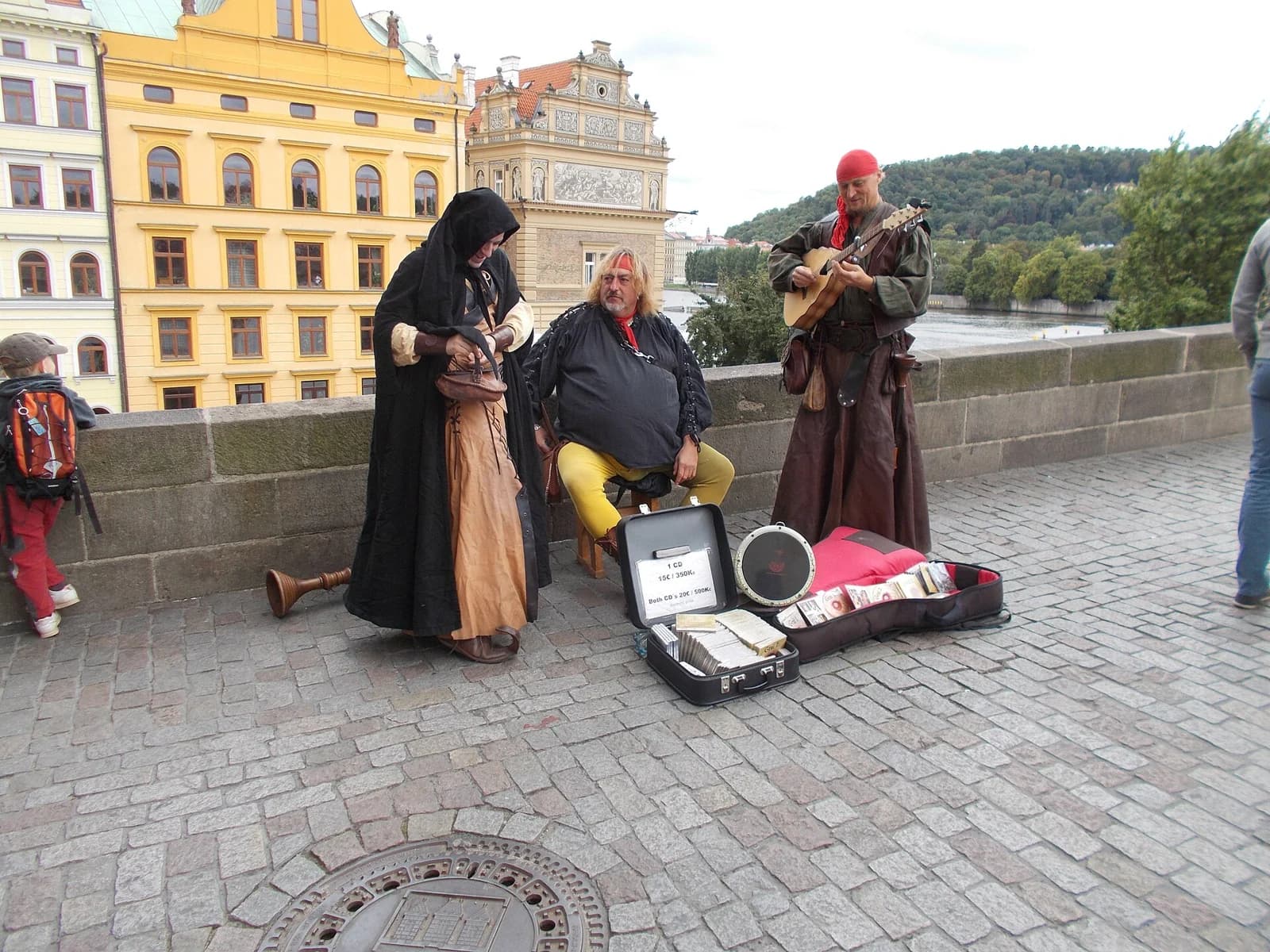 Musicians coordinate a performance with instruments on Charles Bridge in Prague.